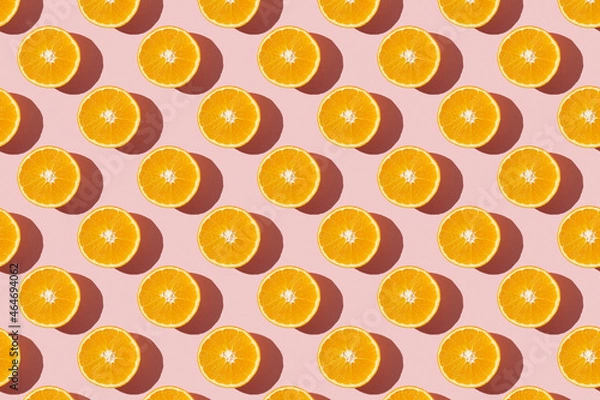 Fototapeta Fruit pattern of fresh ripe slice orange on pink background. Top view, copy space for your text. Fruit composition, healthy concept.