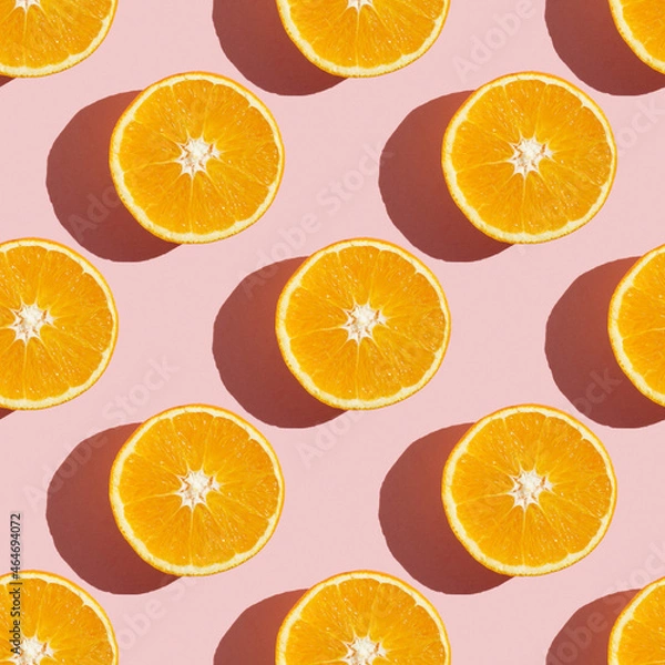 Fototapeta Fruit pattern of fresh ripe slice orange on pink background. Top view, copy space for your text. Fruit composition, healthy concept.