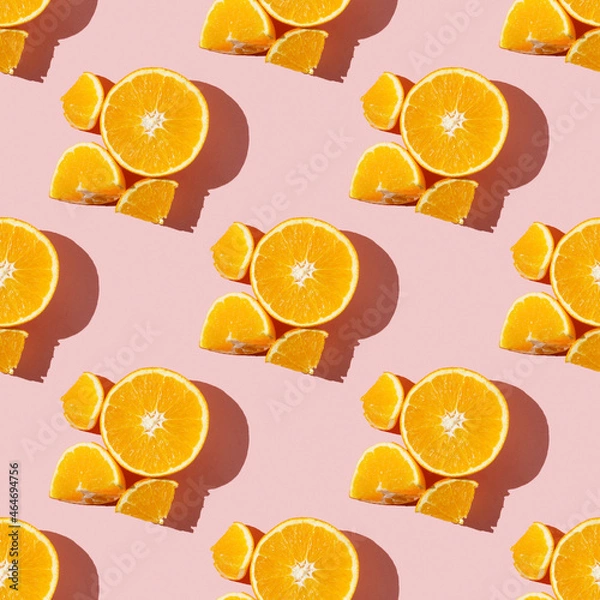 Fototapeta Fruit pattern of fresh ripe slice orange on pink background. Top view, copy space for your text. Fruit composition, healthy concept.