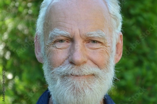 Fototapeta Portrait of a happy smiling elderly gray-haired man with a gray beard and mustache close-up