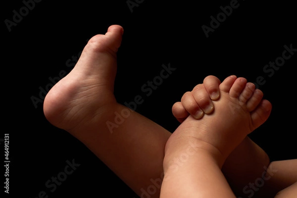 Obraz Close up newborn fingers feet and hands isolated on black background 