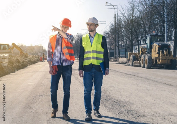 Fototapeta Field Inspectors at Building Construction Site. Land inspector checking a construction site.