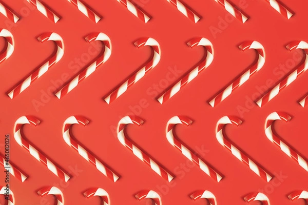 Fototapeta Traditional sweet candy cane Christmas new year cookies, flat lay pattern on red background