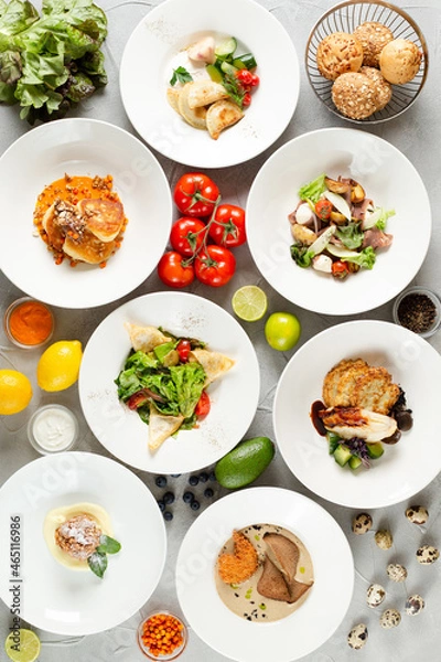 Fototapeta dinner concept. table with food top view many dish with ingredients on concrete background. light concrete background. summer food selection