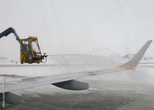 Obraz De-icing plane flying in arctic conditions