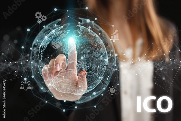 Fototapeta Business, Technology, Internet and network concept. Young businessman working on a virtual screen of the future and sees the inscription: ICO