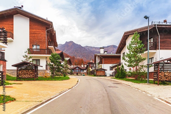 Fototapeta Traditional chalet houses and hotels in Rosa Khutor resort. Mountain Olympic village in the Caucasus Mountains.