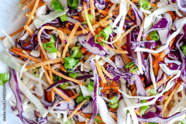 Fototapeta Vegetable background close-up, banner. Red cabbage and carrot vegetable salad, coleslow salad