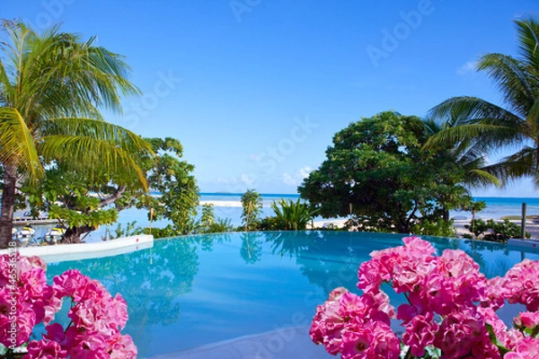 Obraz The pool on the seashore in tropical plants and flowers