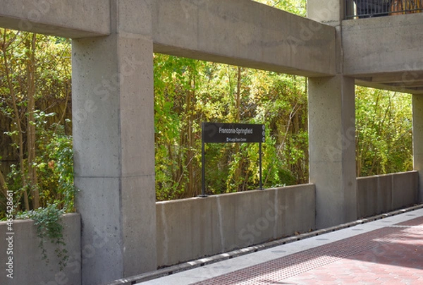 Fototapeta Springfield, Virginia, USA - October 25, 2021: Station Sign at the Franconia-Springfield Metro Station with an Ivy Covered Wall in the Background