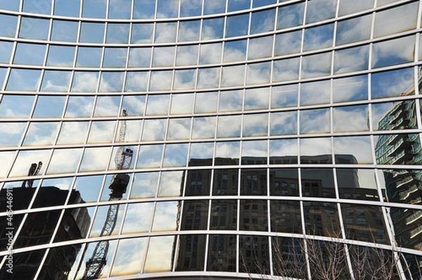 Obraz tower crane reflected on concave window