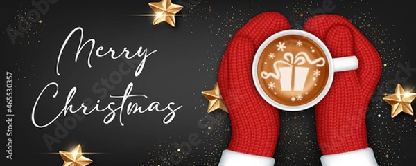 Obraz Hands in knitted mittens holding a cup of coffee. Christmas greeting card template