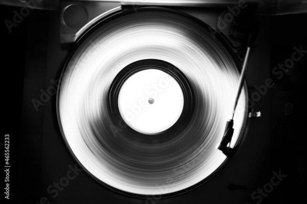 Fototapeta Abstract black and white image of a turntable for vinyl records. Long shutter speed. Motion tracks.