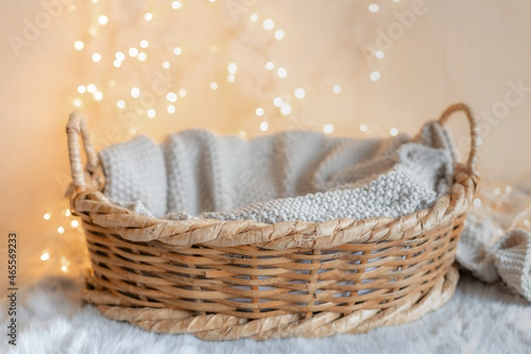 Obraz basket for baby with knitted blanket and bokeh background