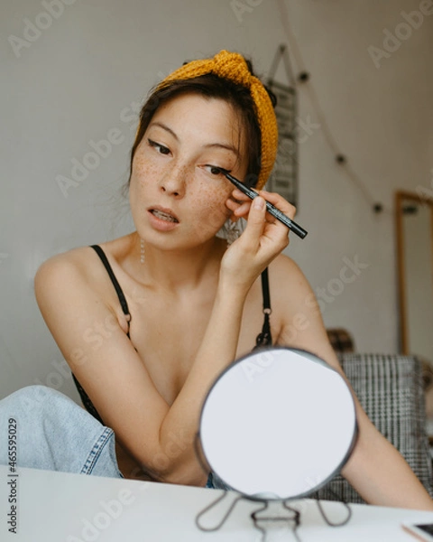 Obraz attractive woman doing makeup at home 