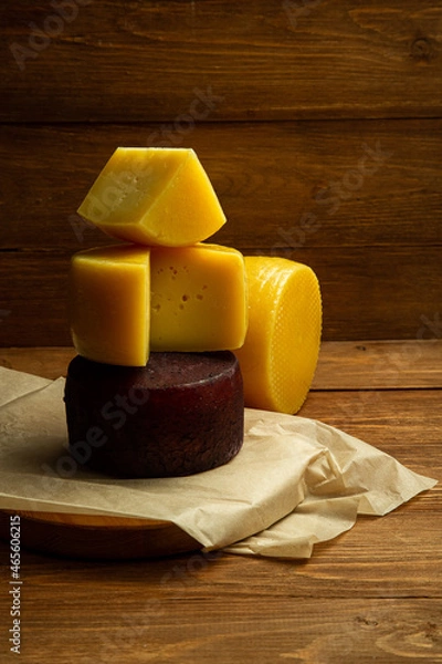 Fototapeta composition of different types of sliced cheese: hard, mature, cheese with mold. Cheese slicing with fruit - grapes and figs. concept is cheese handicraft production, restaurant.