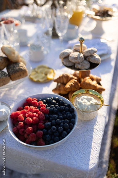 Obraz Wild berries on the table in a beautiful plate. Raspberries and blueberries in a plate, a beautiful table with food.