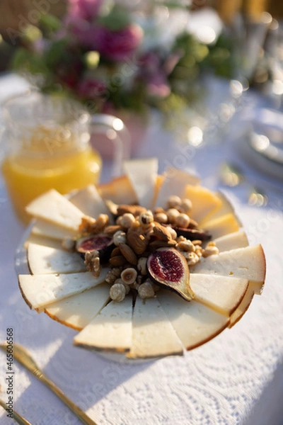 Obraz Cheese with nuts and figs in a plate. Sliced cheese, figs, dried fruits.