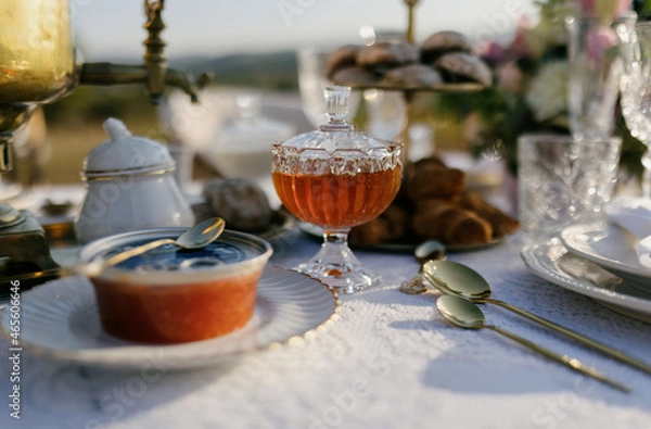 Obraz Honey in a glass plate on a beautiful table with food. Honey and red caviar on the table.