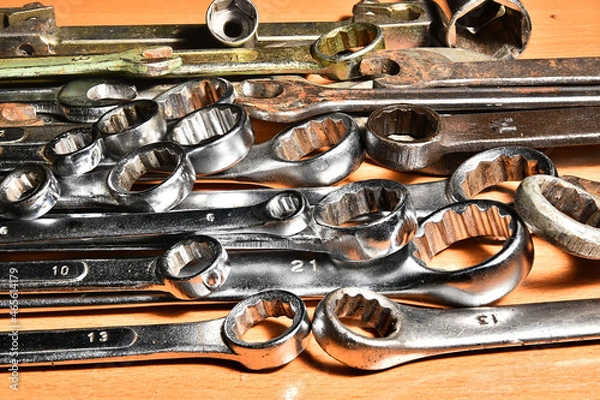 Fototapeta The wrench horn and cap keys are laid on a wooden table in a certain order