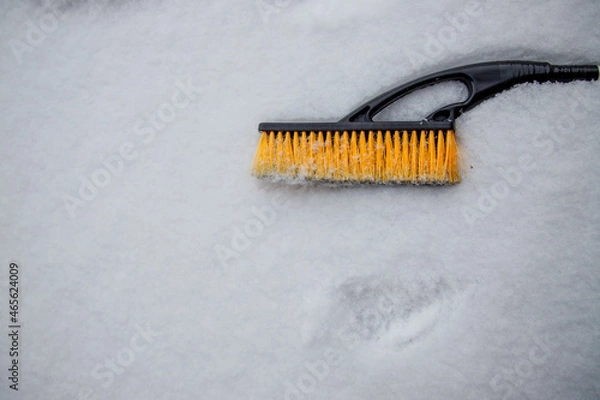 Obraz brush for cleaning car lies on the snow