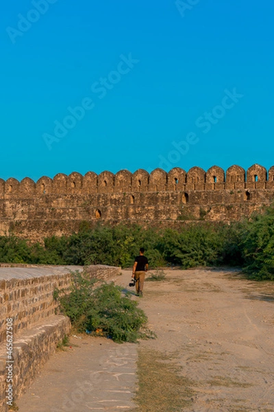 Obraz Man walking in Rohtas Fort towards the wall