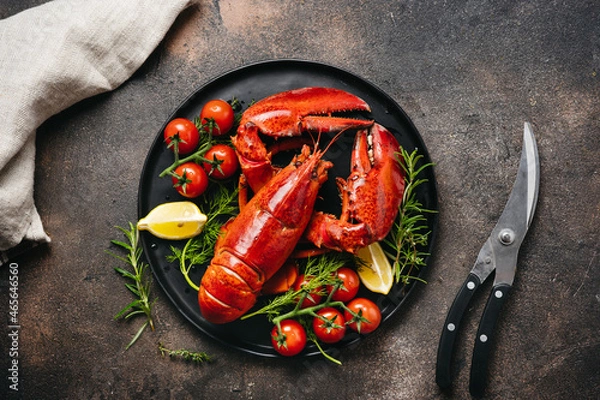Obraz Delicious freshly cooked lobsters on black plate. Top view. Seafood and holiday concept. Gourmet food