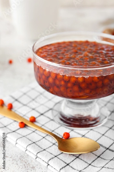 Obraz Glass vase with tasty rowan jam on table, closeup
