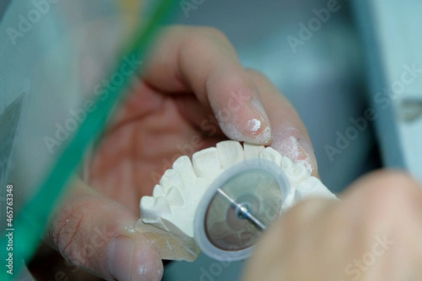 Obraz Dental Technician.Close-up of a man working on creating a human jaw with teeth