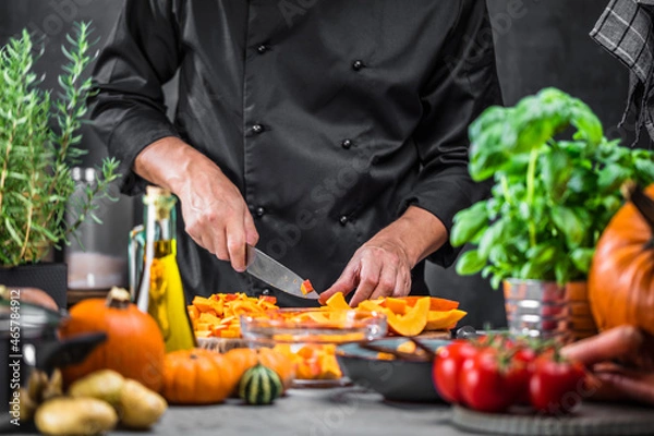 Fototapeta Chef cutting fresh and delicious pumkin and vegetables for cooking soup