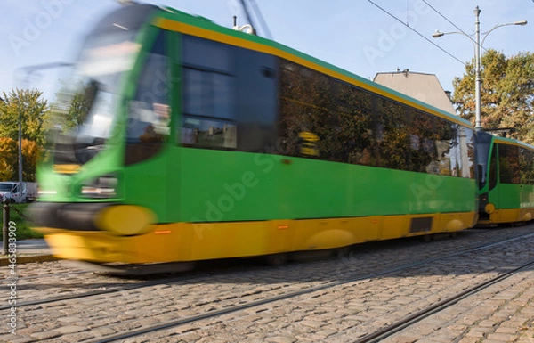 Fototapeta Tram blurred by motion, abstract photo, public transportation in Poznan, Poland.