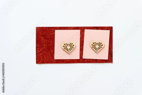 Fototapeta wooden heart shapes on red and pink paper squares
