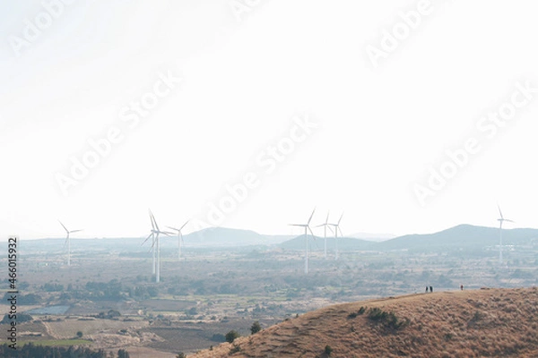 Fototapeta Wind power generation and scenery from the parasitic cone of Jeju Island in the winter.

