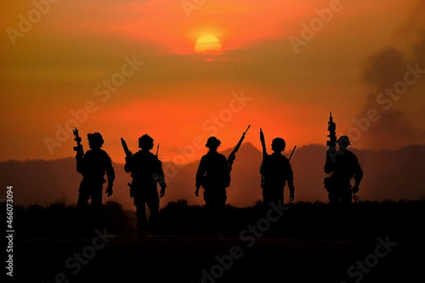 Fototapeta The silhouette of a military soldier with the sun as a Marine Corps for military operations