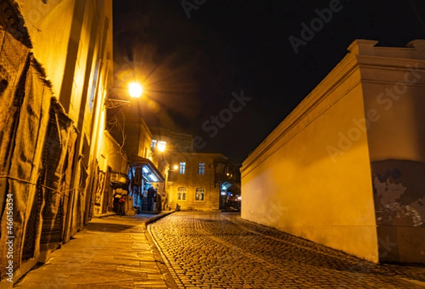 Fototapeta Street at night in thStreet at night in the Old City of Baku illuminated by lanterns. Inner city. Azerbaijan.e old city of Baku. Inner city. Azerbaijan.