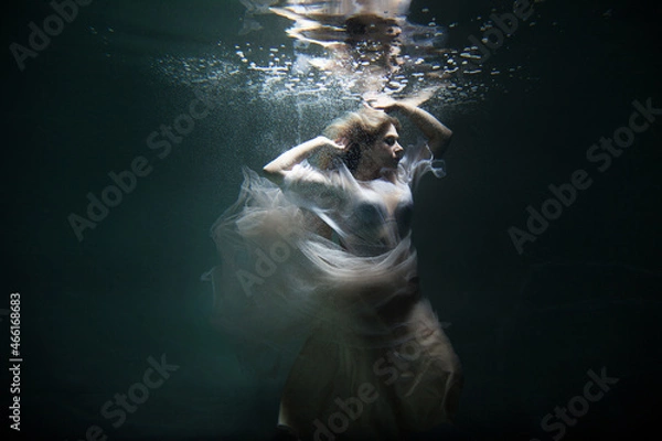 Fototapeta bride under water in a beautiful white dress