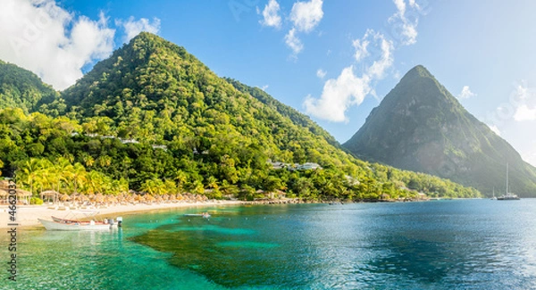 Fototapeta Caribbean beach with palms and straw umrellas on the shore with Gros Piton mountain in the background, Sugar beach, Saint  Lucia