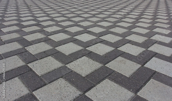 Fototapeta the ornament of the driveway laid out of different stone gray paving slabs