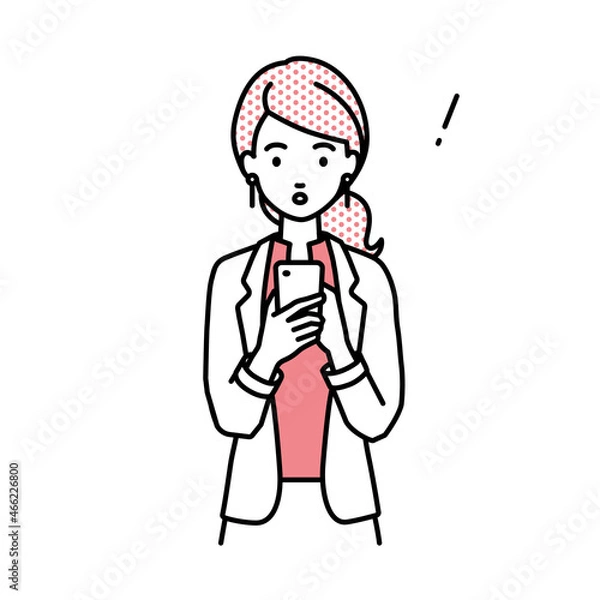 Fototapeta 立ってスマートフォンを操作して何かに気づいて驚いたジャケットの女性