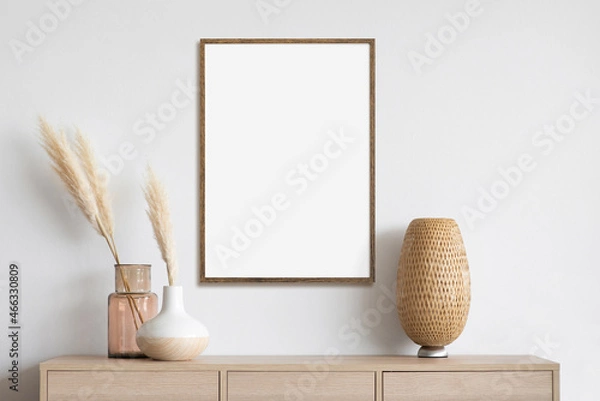 Fototapeta Blank picture frame mockup on gray wall. White living room design. View of modern scandinavian style interior with artwork mock up on wall. Home staging and minimalism concept