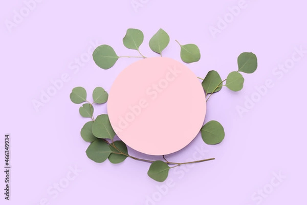 Fototapeta Blank paper sheet and eucalyptus branches on color background