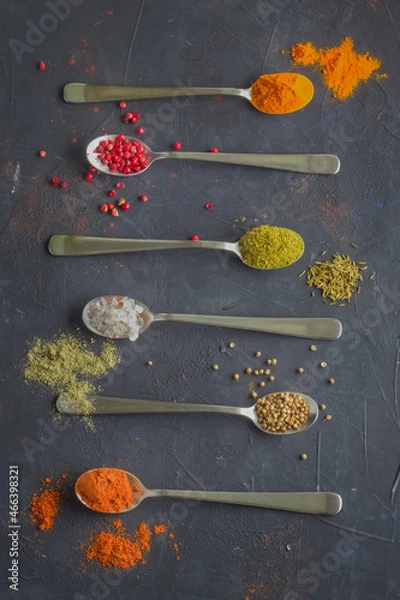 Fototapeta Multicolored spices on a blue background. Top view.