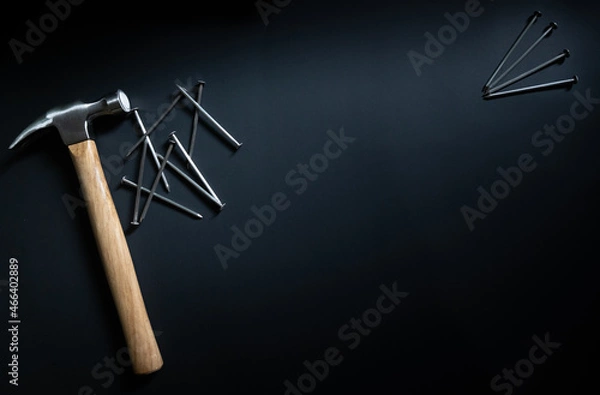 Obraz hammer and nails on black background