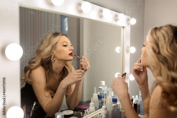 Obraz make up artist applying make up in mirror