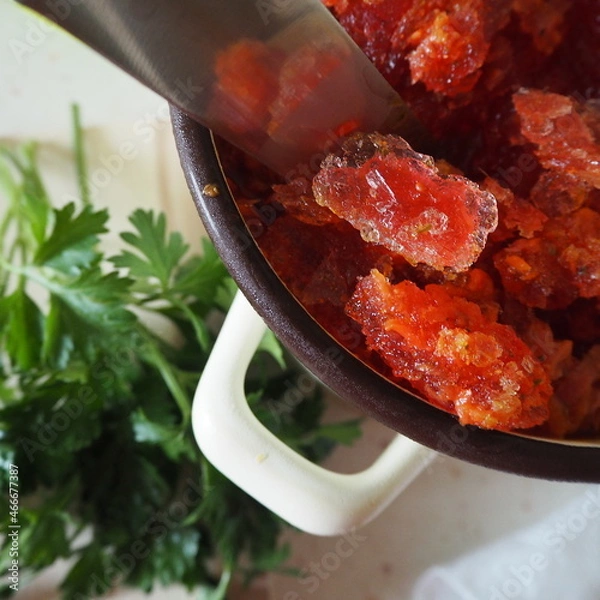 Fototapeta Red soup crystals with parsley