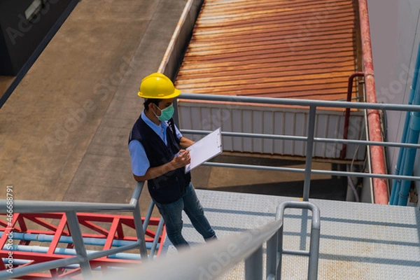 Fototapeta Engineers monitor and control work in the construction area.