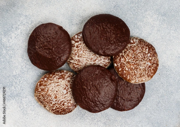 Fototapeta Nuremberg gingerbreads with nuts (almonds, hazelnuts, walnuts) in chocolate and sugar glaze. Lebkuchen. Traditional Christmas and new year treats. Selective focus, top view