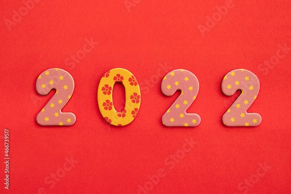 Fototapeta Decorative numbers 2022 new year on red background with copy space