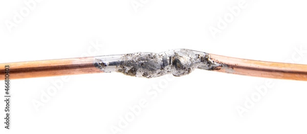 Fototapeta Two copper wires are soldered together isolated on a white background.Soldering wires with tin