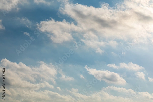 Fototapeta Blue sky with clouds and sun. High under with rays from the sun in the right corner of the frame